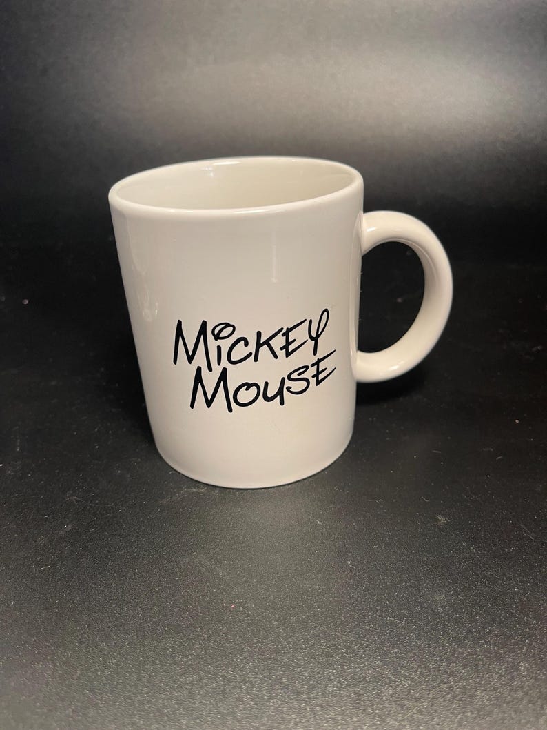 May include: A handmade wooden sign with the text "Welcome to our home" in a handwritten style. The sign is painted white with black lettering and a distressed finish, suitable for indoor or outdoor use.