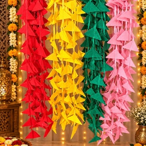 May include: Four vertical garlands made of triangular fabric pieces in red, yellow, green, and pink. Each garland consists of multiple fabric triangles attached to a central ribbon, hanging side by side from a horizontal rod for decorative display.