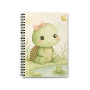 May include: Spiral-bound notebook featuring a watercolor illustration of a smiling green turtle with a pink bow, sitting near a pond with a frog and a butterfly. The notebook has a white cover and a metal spiral binding.