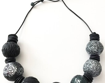 Polymer clay bead statement necklace strung on Greek leather cord.