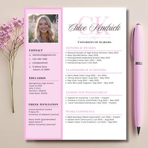May include: A pink and white resume template featuring a photo of a smiling woman. The resume includes contact information, education, honors, activities, community involvement, and work experience. A pink pen rests on the right side.
