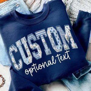 May include: A set of three ceramic mugs with a speckled, matte finish. The mugs are in shades of cream, light gray, and dark gray. Each mug has a simple, minimalist design, perfect for coffee or tea.