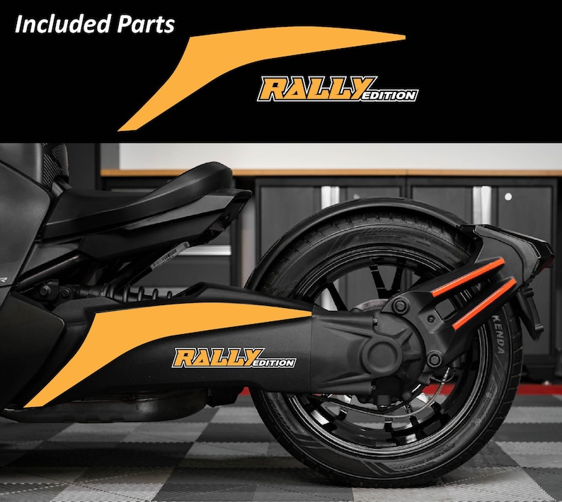 May include: Black and orange motorcycle with the text "RALLY EDITION". The image shows the rear wheel and side panel of the vehicle, with orange accent decals. The words "Included Parts" are at the top of the image.
