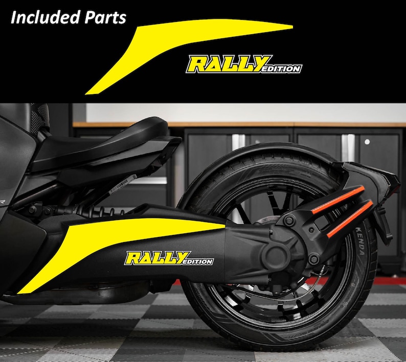 May include: Black and yellow motorcycle decals with the text "RALLY EDITION". The decals are yellow with black accents and are designed to fit on the side of a motorcycle. The image also shows the rear wheel and suspension.