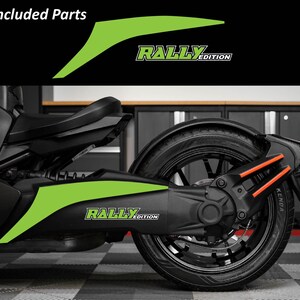 May include: Black and green motorcycle with lime green accent decals. The decals have the text "RALLY EDITION" in white. The image also includes the words "Included Parts" in white.
