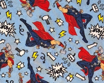 May include: Light blue fabric featuring a repeating comic book pattern of Thor in a dark blue suit and red cape, wielding a hammer. The design includes white stars, yellow lightning bolts, white arrows, and comic-style speech bubbles with the text THOR.