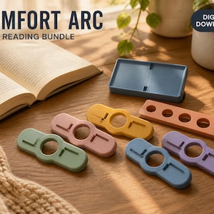 May include: A digital download bundle titled COMFORT ARC 7 STL READING BUNDLE featuring seven 3D printed objects including a rectangular tray, a long strip with five circular holes, and five thumb-style book page holders in green, pink, yellow, blue, and purple.