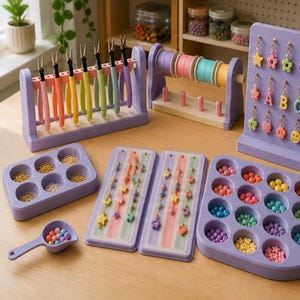 May include: A collection of lavender jewelry-making organizers including a rack with colorful pliers, a spool holder, a display board with hanging charms, two rectangular trays with circular compartments for beads and jump rings, and a small scoop.