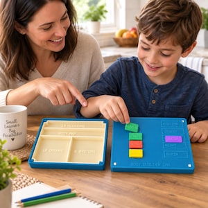 May include: A blue plastic Body Builder Lab educational game set with a beige storage tray and a blue game board. The board features slots for colored rectangular tiles labeled with organ names like Lung, Heart, and Brain, and system labels.