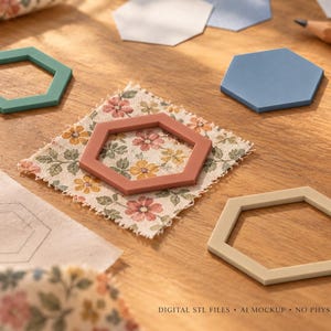 May include: A collection of hexagon-shaped frames in teal, dusty rose, and beige, alongside solid blue and white hexagon cutouts, a floral fabric square, and a pencil. Text reads: DIGITAL STL FILES - AI MOCKUP - NO PHYSICAL ITEM.