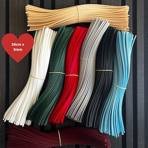 May include: Bundles of flexible silicone rods in beige, white, dark green, red, grey, black, light blue, and maroon. Each rod measures 24cm by 3mm, as indicated by the text on the red heart graphic. The rods are arranged in organised groups.