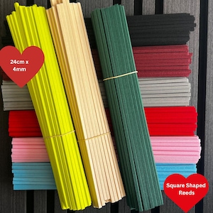 May include: Bundles of square-shaped reeds in various colours including neon yellow, beige, dark green, black, maroon, grey, red, pink, and light blue. Each reed measures 24cm x 4mm as indicated by the text on the red heart-shaped overlays.