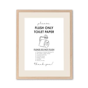 May include: A framed sign with the text "please FLUSH ONLY TOILET PAPER" and a graphic of a toilet paper roll. Below, it reads "PLEASE DO NOT FLUSH" followed by a list of items. The sign is in a light wood frame.