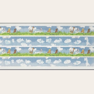 May include: A sheet of scrapbook border stickers featuring a repeating pattern of animals walking on a green grassy path with blue sky and white clouds. The animals include a giraffe, a bear, a white rabbit, and a white bird. The text "Suzy's Zoo Scrapbook Border Stickers" is printed on the right side of the sheet.
