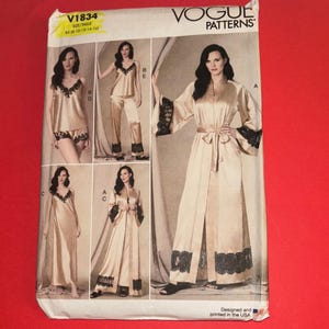 May include: Vogue Patterns sewing pattern featuring a variety of lingerie designs. The pattern includes a satin robe with black lace trim, a camisole and shorts set, and a camisole and pants set. The pattern is printed in the USA.