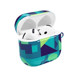 May include: Open, patterned case for wireless earbuds. The case is decorated with a geometric design in shades of blue, green, and purple. Two white earbuds are inside the open case. The case has a small loop on the side.