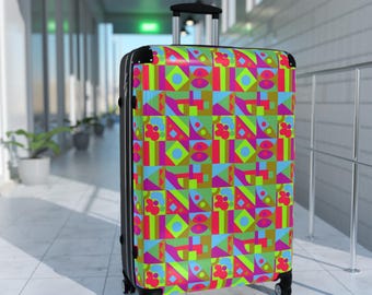 May include: A rolling suitcase with a vibrant geometric pattern in neon green, pink, blue, and brown. The luggage has a black frame, a retractable handle, and four wheels. The design features squares, diamonds, and floral shapes.