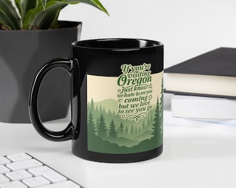 Funny Oregon Black Mug – “You’re Visiting Oregon” Coffee Mug – PNW Humor Mug – Black Glossy Ceramic Mug