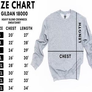 Puede incluir: Una sudadera gris claro Gildan 18000 de mezcla pesada con cuello redondo. La imagen incluye una tabla de tallas con medidas de pecho y largo en cm para las tallas S a 5XL. Las palabras "CHEST" y "LENGTH" est&aacute;n etiquetadas en la sudadera.