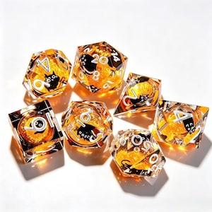 May include: A set of seven polyhedral dice made of clear resin with an orange glitter core. Each die features embedded black cat silhouettes and white numerical markings. The collection includes a d20, d12, d10, d8, d6, d4, and a percentile die.