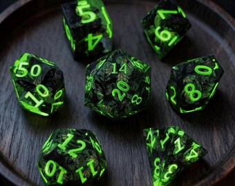 May include: Set of seven polyhedral dice with a black and green butterfly design. The dice have glowing green numbers and are displayed on a dark wooden tray. Ideal for tabletop games.