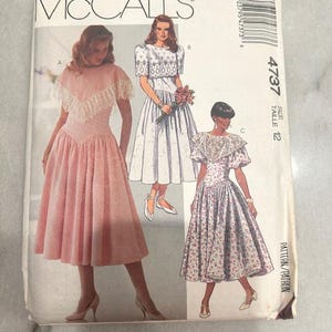 May include: A vintage McCall's sewing pattern featuring illustrations of three different dresses. The pattern cover is white with the McCall's logo at the top. The dresses are in pink, white, and floral patterns. The pattern number is 4737, size 12.