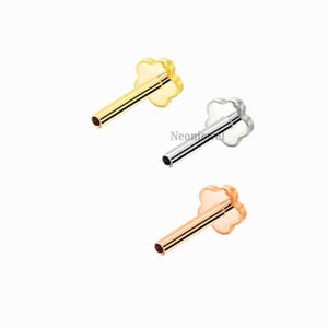 May include: Three stud earrings with a flower-shaped top. One is gold, one is silver, and one is rose gold. Each has a straight post for piercing.