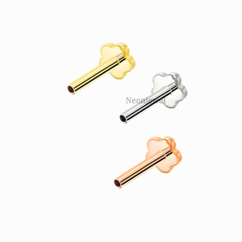 May include: Three stud earrings with a flower-shaped top. One is gold, one is silver, and one is rose gold. Each has a straight post for piercing.