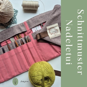 May include: A pink and brown knitting needle case with multiple compartments, holding various knitting needles. A ball of green yarn, a spool of thread, and the text "Schnittmuster Nadeletui" are also visible. The case has a brown strap and a small patch with an illustration.
