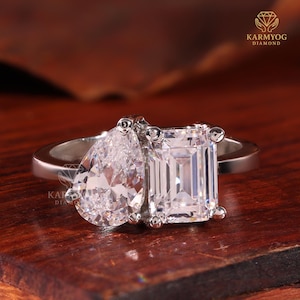 May include: A set of three ceramic mugs with a speckled, matte finish. The mugs are in shades of cream, light gray, and dark gray. Each mug has a simple, minimalist design and a rounded handle.