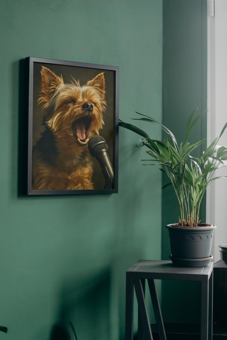 May include: Framed artwork featuring a Yorkshire Terrier with its mouth open, singing into a black microphone. The dog has brown and black fur. The artwork is in a black frame and hangs on a green wall.