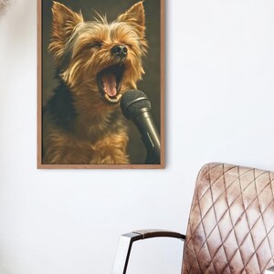 May include: A framed print featuring a Yorkshire Terrier with its mouth open, as if singing into a microphone. The dog has brown and black fur. The microphone is black. The frame is a light brown color.