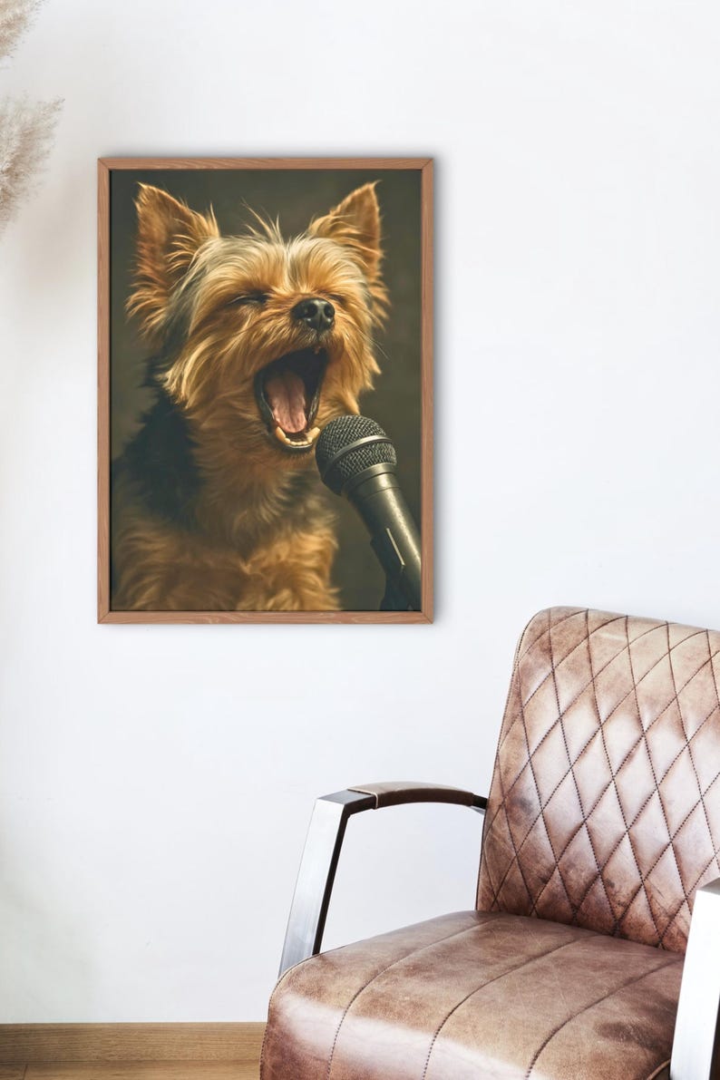 May include: A framed print featuring a Yorkshire Terrier with its mouth open, as if singing into a microphone. The dog has brown and black fur. The microphone is black. The frame is a light brown color.