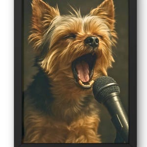 May include: A framed print featuring a Yorkshire Terrier with its mouth open, as if singing into a microphone. The dog has brown and tan fur. The microphone is black. The background is a dark, muted color.