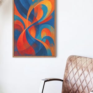 May include: Abstract art print in a wooden frame. The artwork features flowing, curved shapes in shades of blue, orange, and red. The painting is displayed on a white wall, with a brown leather chair in the foreground.