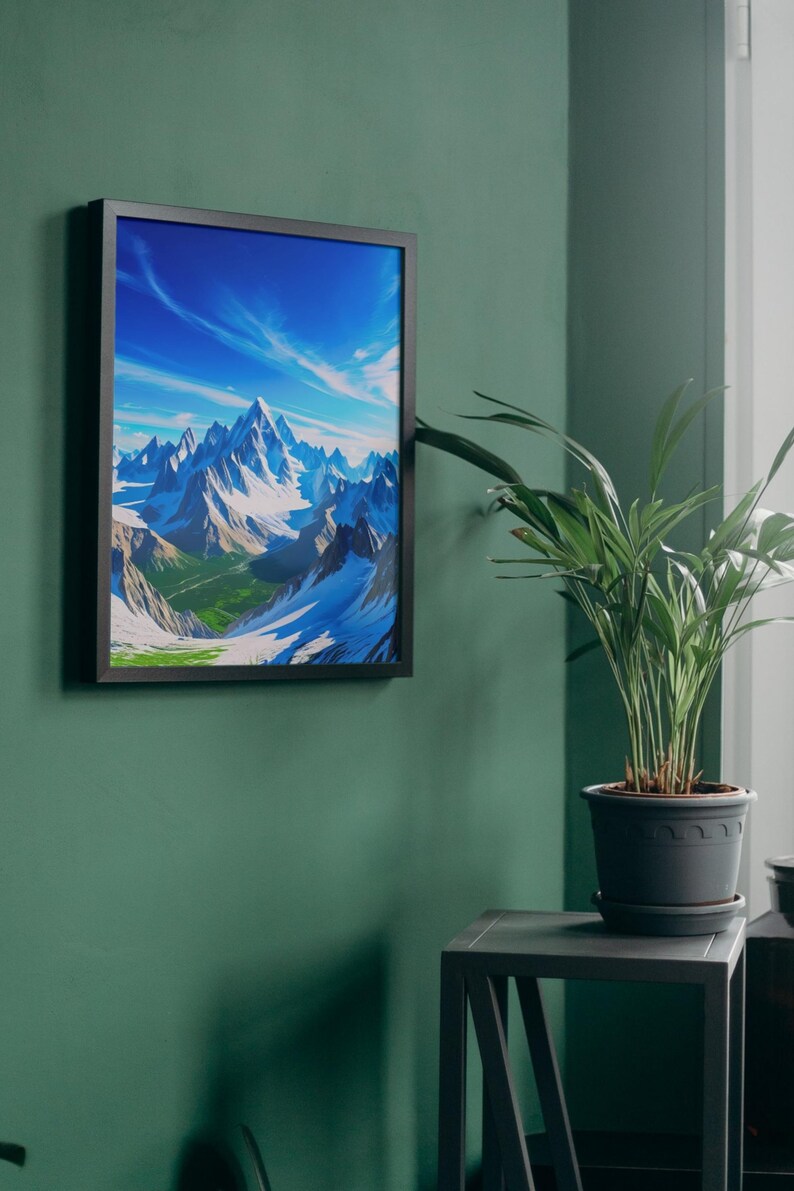 May include: A framed art print depicting a mountain range with snow-capped peaks under a bright blue sky with wispy clouds. The artwork is framed in a black frame and hangs on a dark green wall. A potted plant sits on a small table nearby.