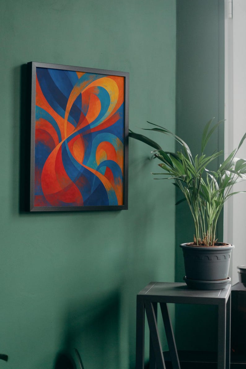 May include: Abstract art print in a black frame. The artwork features flowing, curved shapes in shades of blue, orange, and red. The framed art is mounted on a green wall. A potted plant sits on a small table next to the artwork.