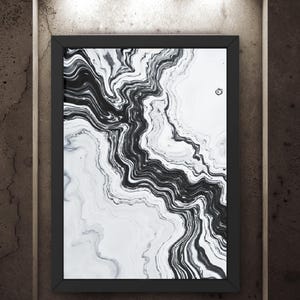 May include: A framed abstract art print with a black and white marble design. The artwork features flowing, swirling patterns in shades of gray and black against a white background. The print is displayed in a black frame, mounted on a textured, dark brown wall.
