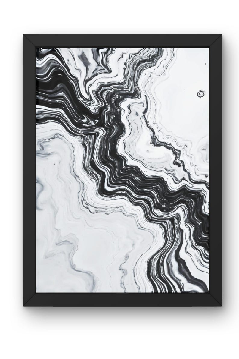 May include: Abstract black and white art print in a black frame. The artwork features a flowing, marbled design with swirling patterns of black and gray against a white background. The frame is rectangular.