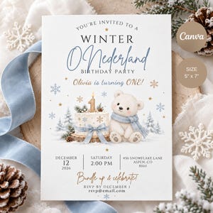 May include: A 5" x 7" winter-themed birthday invitation card featuring a white polar bear wearing a blue scarf, a birthday cake with a number one candle, pine trees, and snowflakes. The text reads: You're invited to a Winter O'Nederland Birthday Party, Olivia is turning ONE!, December 12, 2026, 2:00 PM, 456 Snowflake Lane, Aspen, CO 81611, Bundle up & celebrate!, RSVP by December 1, rsvp@email.com.
