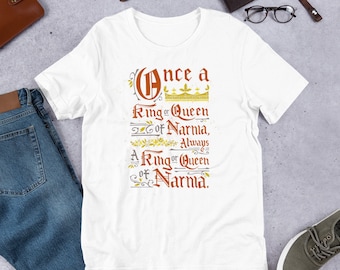 May include: White t-shirt with a brown and gold graphic print that reads "Once a Ring or Queen of Narnia, Always a Ring or Queen of Narnia."