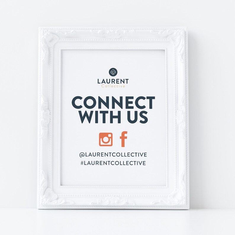 May include: White framed sign with the text "LAURENT Collective CONNECT WITH US" and social media icons for Instagram and Facebook. The text below the icons reads "@LAURENTCOLLECTIVE #LAURENTCOLLECTIVE".