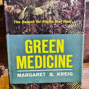 May include: A vintage book titled "Green Medicine" by Margaret B. Kreig. The cover features a teal background with large yellow text. The top portion displays a jungle scene with the text "The Search for Plants that Heal."