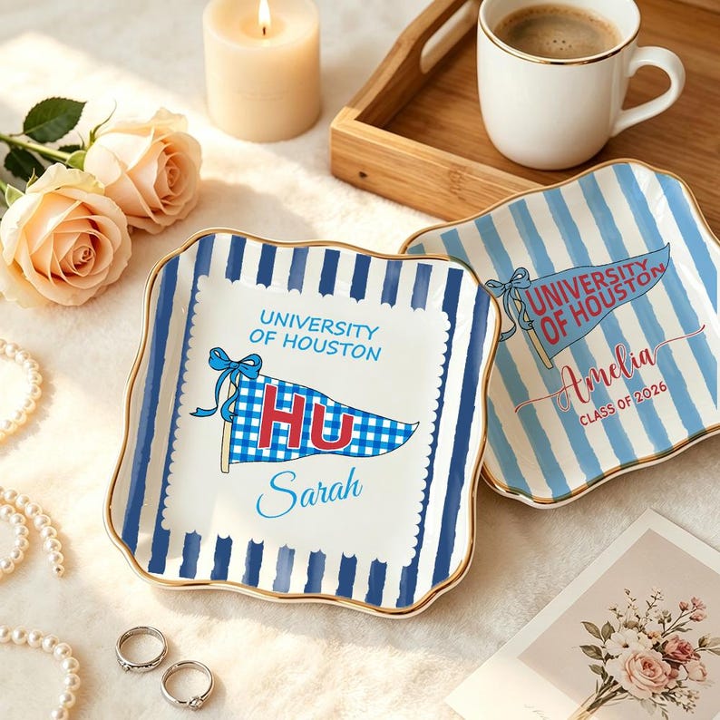 May include: Two square ceramic plates with blue and white stripes and gold trim. One plate features a pennant with "University of Houston" and "HU" text, and the name "Sarah". The other plate has "Amelia" and "Class of 2026".