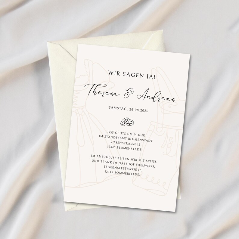 May include: A wedding invitation with a cream-colored envelope and a matching card. The card features the text "WIR SAGEN JA!" and the names "Theresa & Andreas" in elegant script. Additional text includes the date and location details.