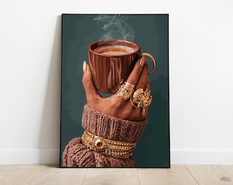 May include: A framed art print depicts a hand holding a brown coffee mug with steam rising. The hand is adorned with gold rings and bracelets, and is wearing a brown sweater. The background is a dark teal color.