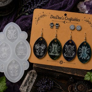 May include: A silicone mold featuring four oval cavities with etched creature designs and a display card labeled DeeDee's Craftables holding four oval-shaped earrings and two pairs of small stud earrings with mushroom and floral patterns.