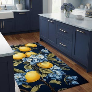 Peut inclure: Tapis rectangulaire avec un fond bleu foncé orné d'un motif de grands citrons jaunes, de fleurs bleues et de feuilles vertes. Le tapis est posé sur un sol en bois dans une cuisine.