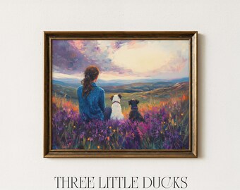 May include: A framed art print featuring a person and two dogs overlooking a scenic landscape. The artwork is dominated by purple and yellow hues, with the text "THREE LITTLE DUCKS - ART & DESIGN" at the bottom.