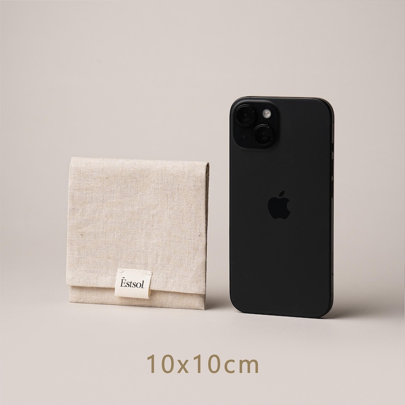 May include: A beige linen pouch with a folded flap, next to a black smartphone. The pouch has a small white label with the text "Estsol". The dimensions of the pouch are 10 x 10 cm, approximately 3.9 x 3.9 inches.